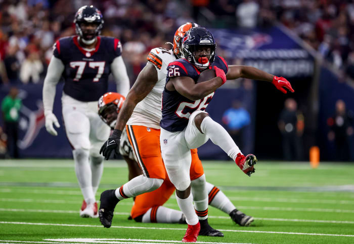 Texans running back Devin Singletary (26) runs with the ball during the second quarter in a 2024 AFC wild card game at NRG Stadium.